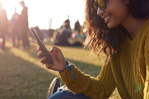woman checking phone at festival - concert stock pictures, royalty-free photos & images