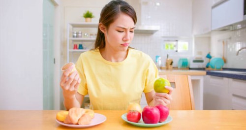 woman choose food - junk food stock pictures, royalty-free photos & images