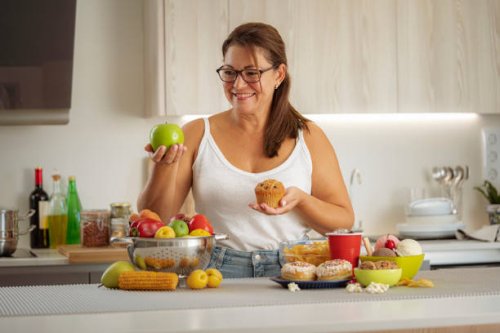woman chooses healthy food rather than junk food - junk food stock pictures, royalty-free photos & images