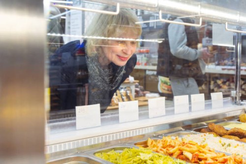 woman choosing ready to eat in supermarket - take out food in cafeteria - junk food stock pictures, royalty-free photos & images