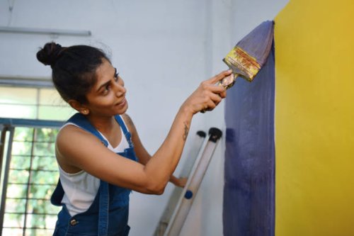 woman coloring interiors of her workshop - home decoration stock pictures, royalty-free photos & images