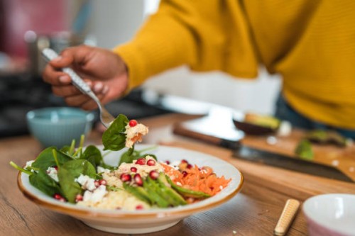 woman creating a vibrant salad for her next food vlog - food stock pictures, royalty-free photos & images