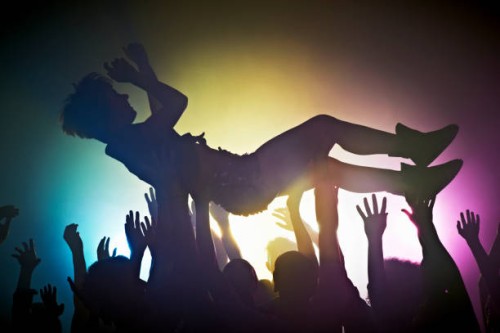 woman crowd surfing - concert stock-fotos und bilder