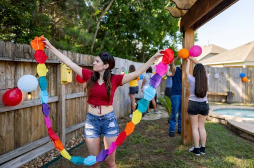 woman decorating the garden for a mexican party - garden decoration stock pictures, royalty-free photos & images