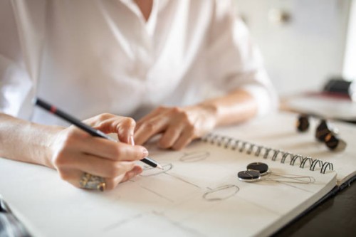 woman designing jewelry in her atelier - fashion stock pictures, royalty-free photos & images