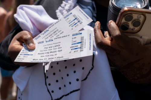 Woman displays her tickets as hundreds of people gather at Washington Square Park for a chance to see Australian rapper and singer The Kid LAROI...