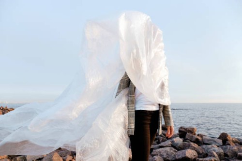 woman dressed in plastic for the sea - fashion stock pictures, royalty-free photos & images