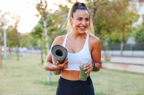 woman drinking vegetable smoothie after fitness running workout - junk food stock pictures, royalty-free photos & images
