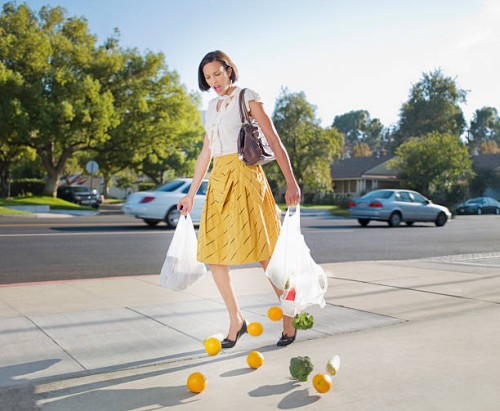 woman dropping groceries on sidewalk - food stock pictures, royalty-free photos & images