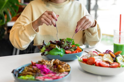 woman eating healthy salad - food stock pictures, royalty-free photos & images