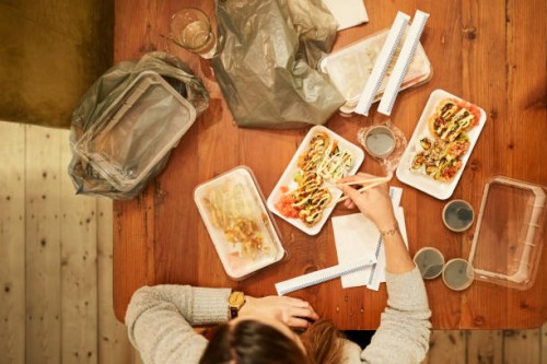woman eating sushi with chopsticks - junk food stock pictures, royalty-free photos & images
