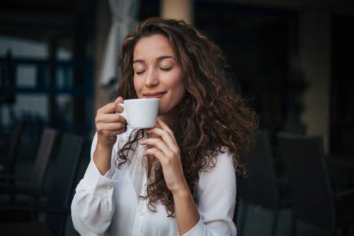 woman enjoying cappuccino in a cafe - coffee stock pictures, royalty-free photos & images