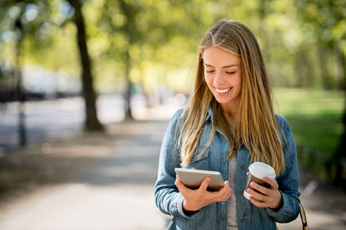 woman enjoying her coffee break at the park - junk food stock pictures, royalty-free photos & images