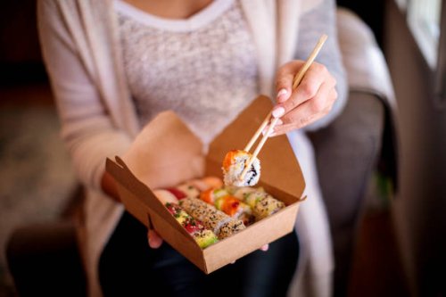 woman enjoying takeaway food at home - junk food stock pictures, royalty-free photos & images