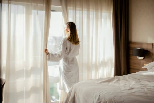 woman enjoys magnificent view from hotel window - travel stock pictures, royalty-free photos & images