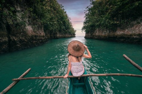 woman exploring a river on small boat at sunset, philippines - travel stock pictures, royalty-free photos & images
