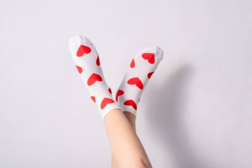woman feets in warm socks with a hearts print on white background - fashion stock pictures, royalty-free photos & images