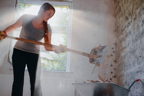 woman filling a wheelbarrow. - home decoration stock pictures, royalty-free photos & images