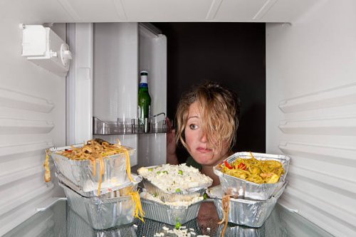 woman finds take-out food containers in fridge. - junk food stock pictures, royalty-free photos & images