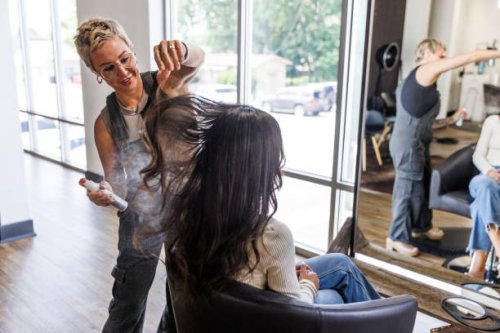woman getting hair styled at salon - hairstyle stock pictures, royalty-free photos & images