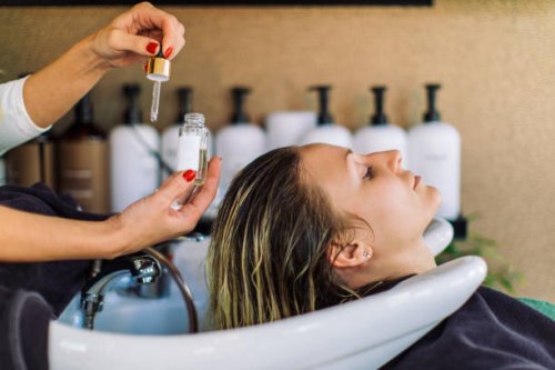 woman getting her hair washed in hair salon - hairstyle stock pictures, royalty-free photos & images
