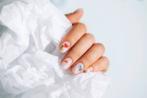 woman hand with beautiful colorful manicure is holding white paper. trendy bright colors of the year - fashion stock pictures, royalty-free photos & images