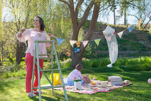 woman hanging bunting outdoors - garden decoration stock pictures, royalty-free photos & images
