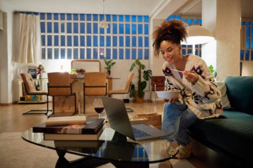 woman having dinner and watching movie at home - junk food stock pictures, royalty-free photos & images