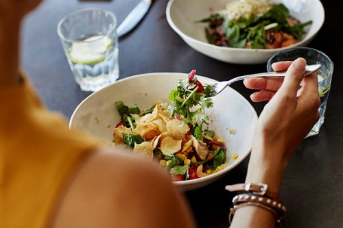 woman having food at restaurant table - food stock pictures, royalty-free photos & images