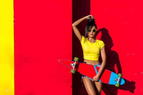 woman holding scateboard - fashion stock pictures, royalty-free photos & images