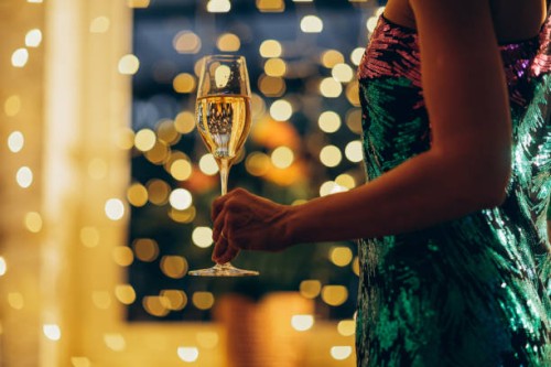 woman in a festive dress with a glass of champagne in her hand. - fashion stock pictures, royalty-free photos & images