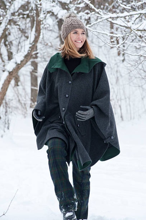woman in heavy cape walking in snow - fashion stock pictures, royalty-free photos & images