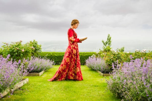 woman in medieval costume reading book in garden - garden decoration stock pictures, royalty-free photos & images