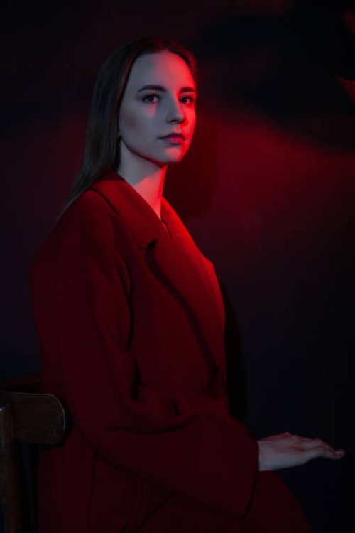 woman in stylish coat in dark studio - fashion stock pictures, royalty-free photos & images
