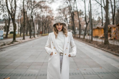 woman in white wardrobe walking through the park - fashion stock pictures, royalty-free photos & images