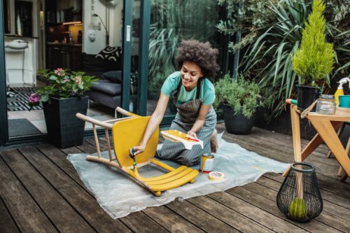 woman is coloring a chair at home - home decoration stock pictures, royalty-free photos & images