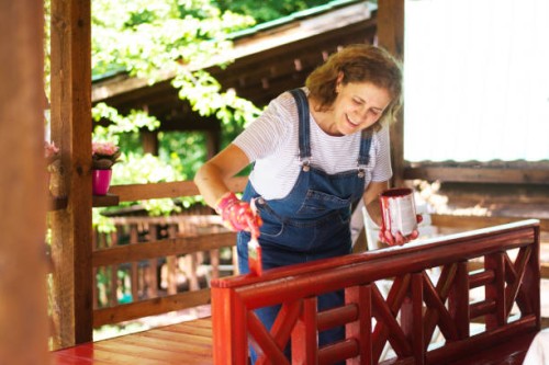 woman is coloring the fence at home - garden decoration stock pictures, royalty-free photos & images