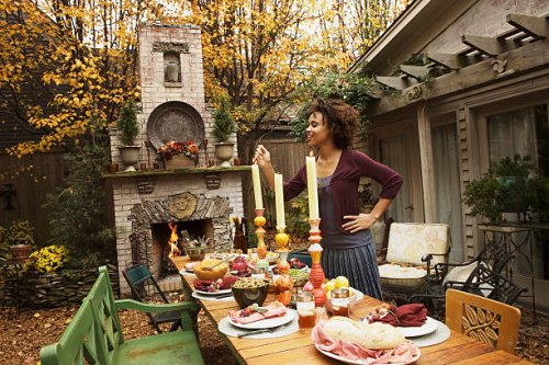 woman lighting candles on table - garden decoration stock pictures, royalty-free photos & images