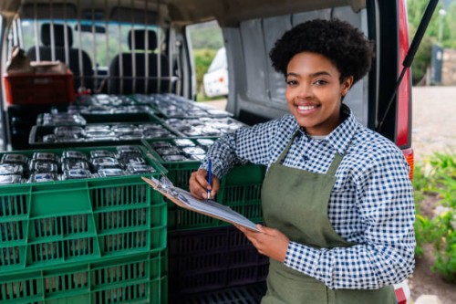woman loading a truck with a blueberry order ready for distribution - food stock pictures, royalty-free photos & images