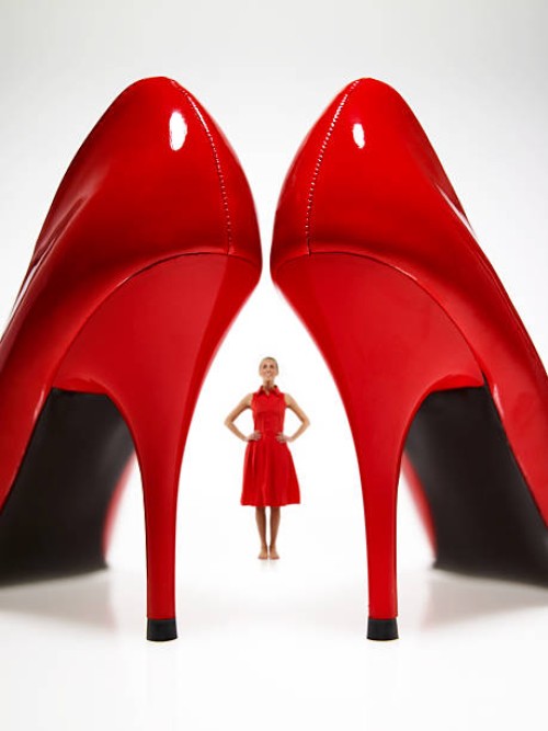 woman looking at large red heels - fashion stock pictures, royalty-free photos & images