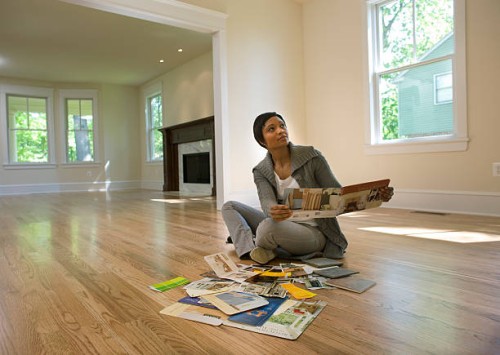 woman looking at paint samples in empty room - home decoration stock pictures, royalty-free photos & images