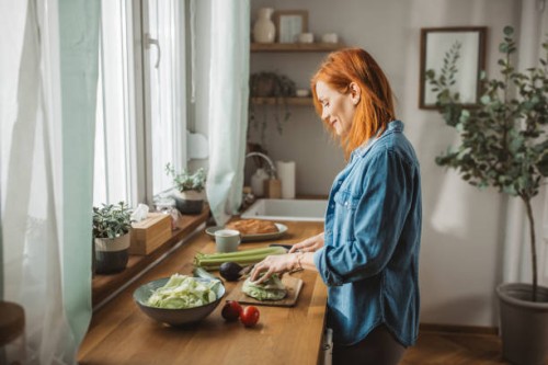 woman making salad in the home kitchen - food stock pictures, royalty-free photos & images
