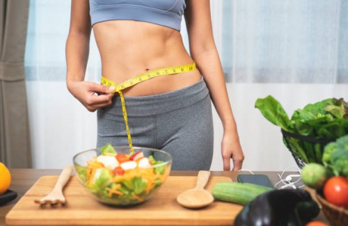 woman measuring her waist - food stock pictures, royalty-free photos & images