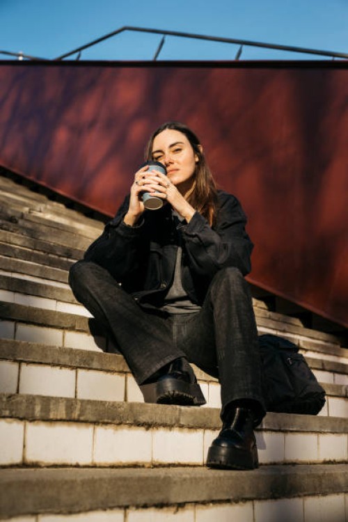 woman on a public park with a coffee mug - junk food stock pictures, royalty-free photos & images