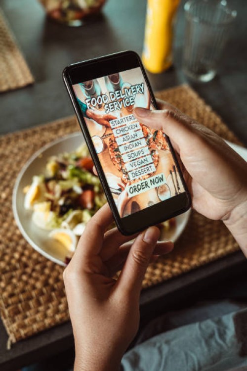 woman ordering food with a food delivery service - junk food stock pictures, royalty-free photos & images