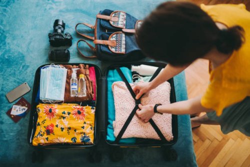 woman packing suitcase for travel - travel stock pictures, royalty-free photos & images