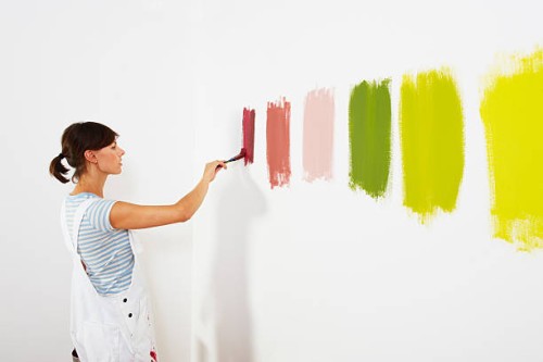 woman painting colour swatches on wall - home decoration stock pictures, royalty-free photos & images