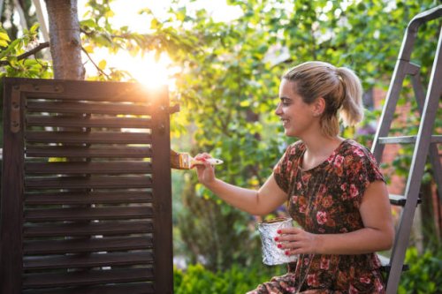 woman painting in garden at sunset - garden decoration stock pictures, royalty-free photos & images