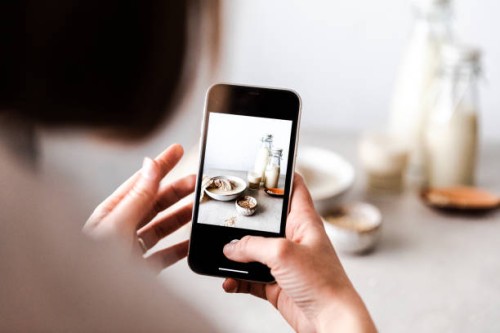 woman photographing freshly made oat milk - food stock pictures, royalty-free photos & images