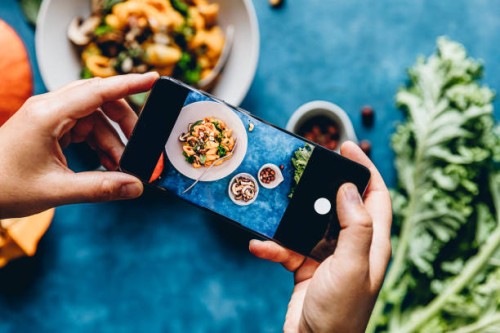 woman photographing pumpkin pasta dish - food stock pictures, royalty-free photos & images